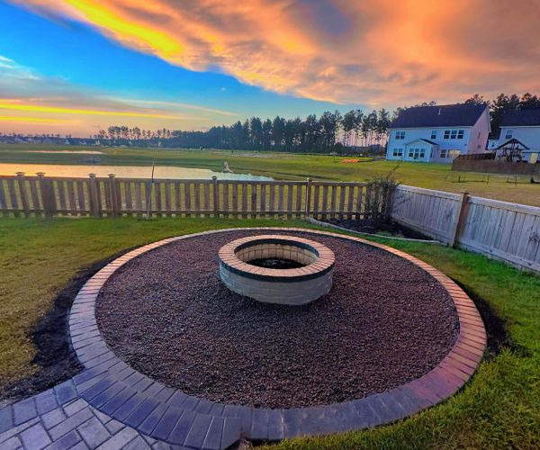 sunset with a fire pit built during landscaping & hardscaping nexton sc